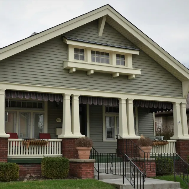 A craftsman bungalow with a covered front porch